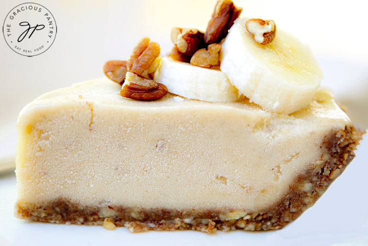 A slice of this Ice Cream Pie from the side shows a nice thick layer of filling with sliced bananas and pecan pieces on top.