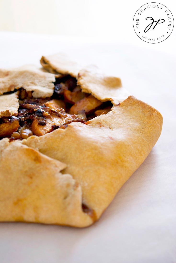 A rustic fig galette sits fresh out of the oven, ready to be sliced.