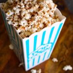 Kettle corn in a popcorn bucket, ready to eat.