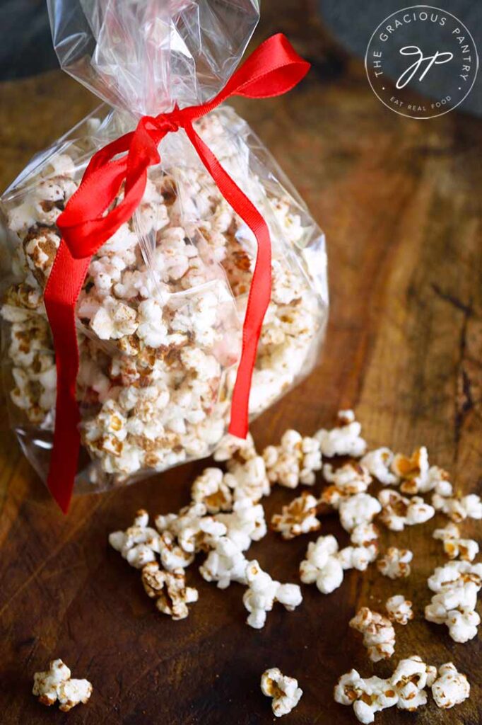 Kettle corn packaged in a clear plastic bag and tied with a red ribbon.