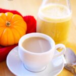 A cup of coffee sits, flavored with this Pumpkin Spice Coffee Creamer, waiting to be enjoyed.
