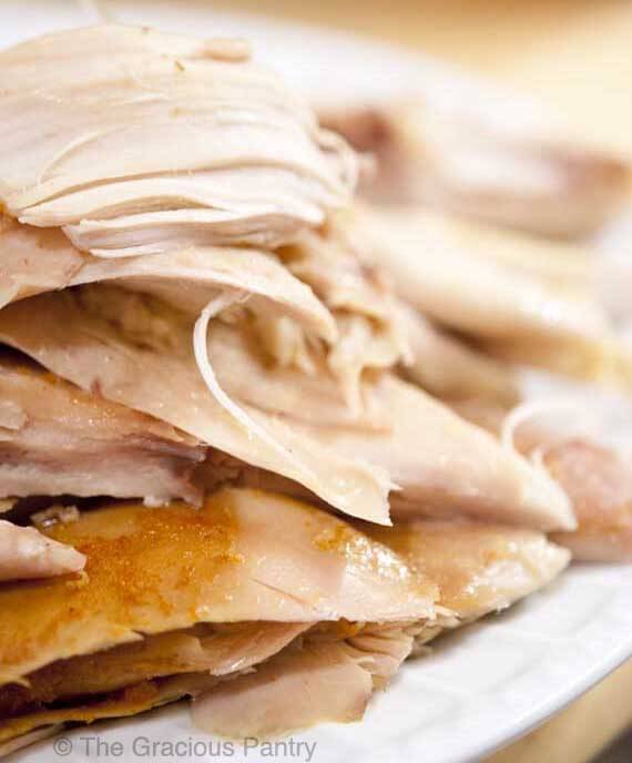 Clean Eating Slow Cooker Rotisserie Chicken, shredded and displayed on a white plate, ready to enjoy as is or in any number of recipes using chicken.