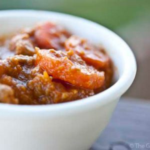 A white bowl filled with pumpkin turkey chili.