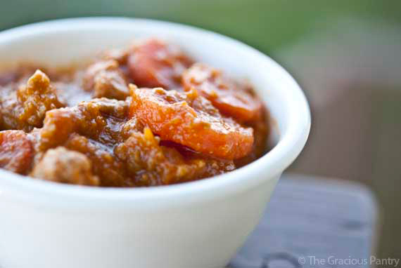 A white bowl filled with pumpkin turkey chili.