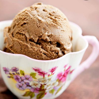 A scoop of Dairy Free Chocolate Ice Cream served in a decorative tea cup.