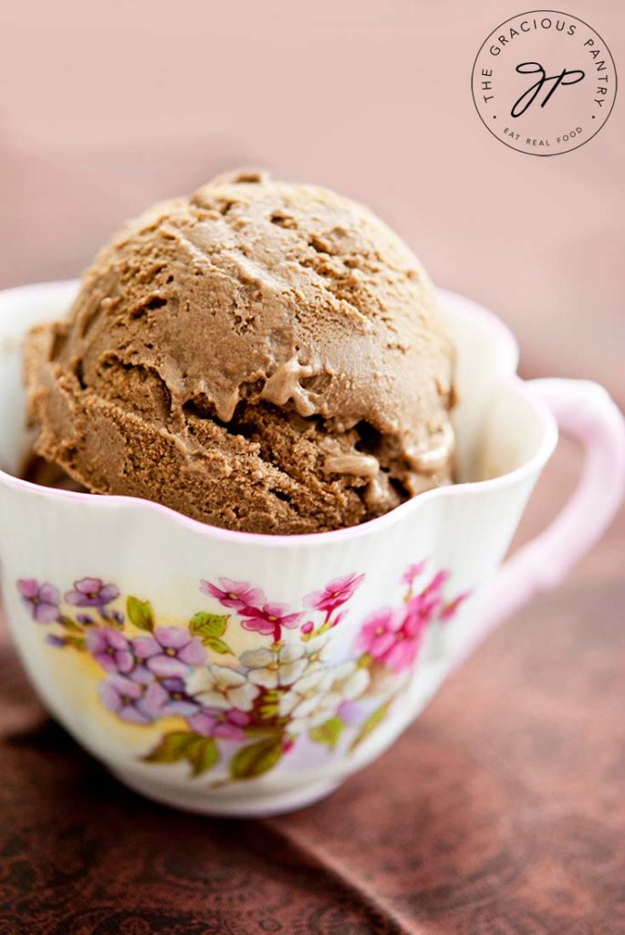 A scoop of Dairy Free Chocolate Ice Cream served in a decorative tea cup.