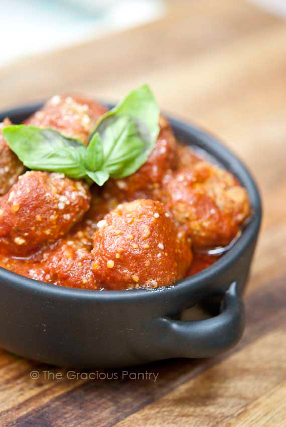 Clean eating slow cooker Italian meatballs recipe served in a dark gray bowl and ready to eat