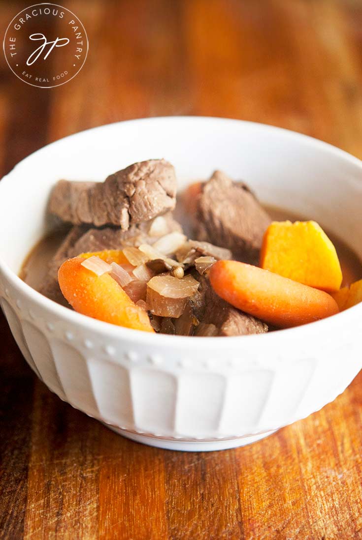 A white bowl sits filled with this Venison Stew Recipe and is ready to eat.