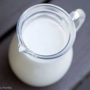 A glass pitcher of milk.