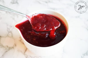 The cooked cranberry sauce in a serving dish, ready to chill in the fridge.