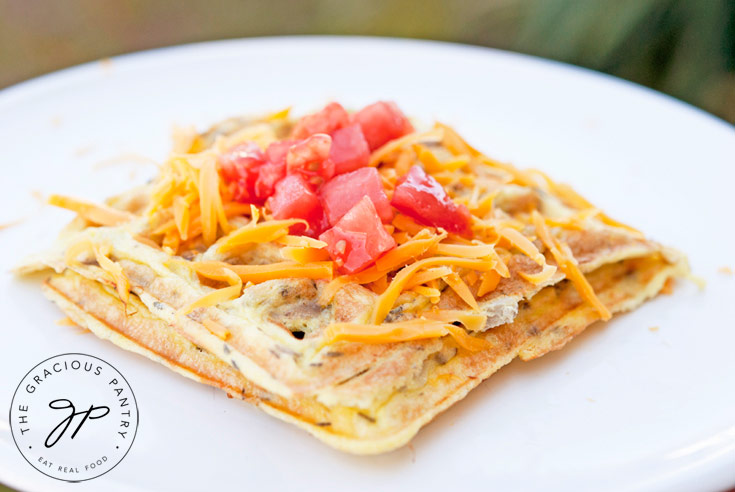 Waffle Iron Omelets topped with cheese and tomatoes.