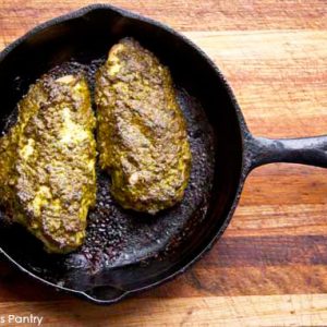 Pesto Chicken in a cast iron skillet.