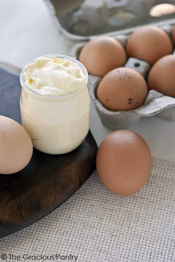 Clean Eating Mayonnaise in a clean jar, displayed with eggs around it, ready to spread on your favorite sandwich.