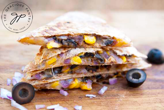 Stuffed Mexican Quesadillas stacked on a cutting board.