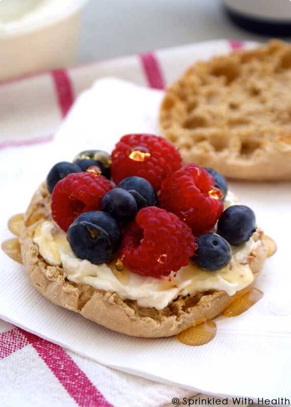 And english muffin with cream and berries on top.