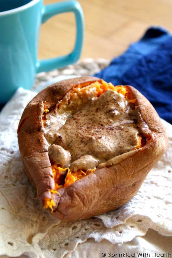 A split open sweet potato is filled with nut butter.