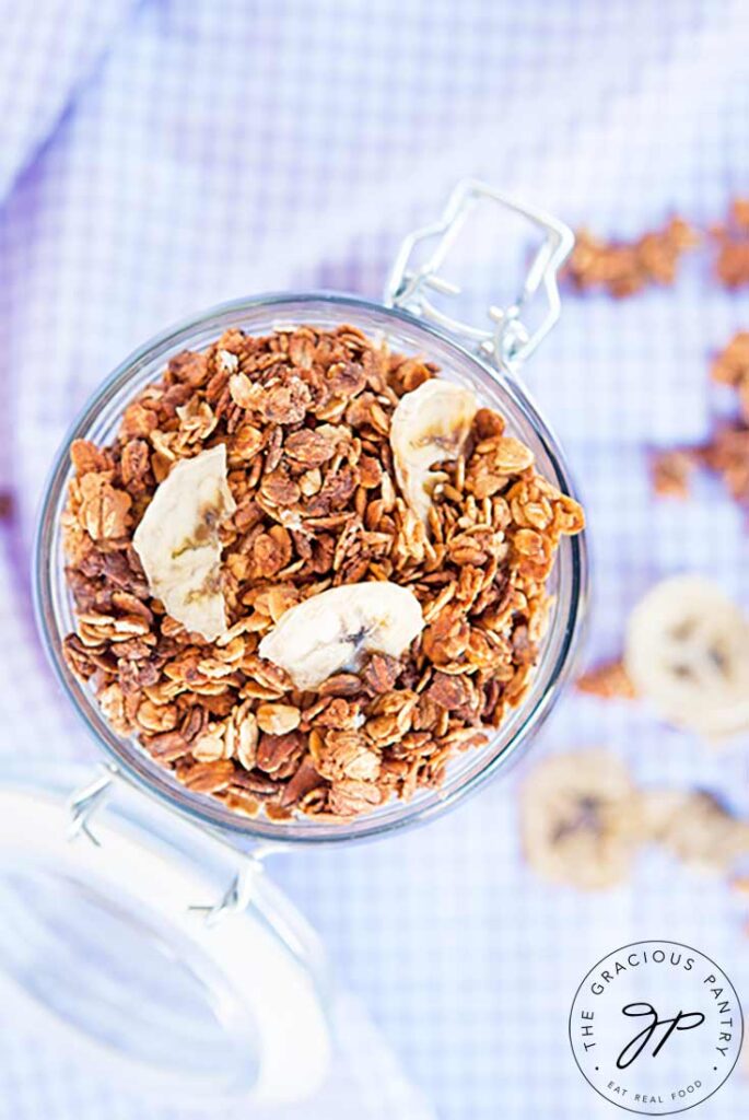 An overhead view looking down into a storage jar filled with Banana Granola.