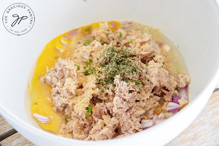 Ingredients for these clean eating tuna patties put together in a mixing bowl, ready to mix for forming the patties.