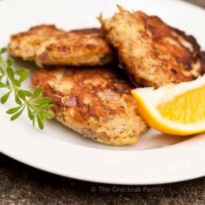Clean Eating Tuna Patties on a white plate with lemon wedge