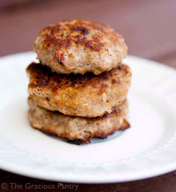 A stack of  Turkey Breakfast Sausages on a white plate.