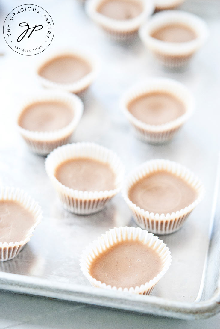 Clean Eating Peanut Butter Fat Bombs straight from the freezer, sitting on a baking pan and ready to be transferred to a storage container.