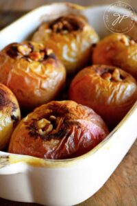 A pan of baked apples sits warm out of the oven, ready to serve.