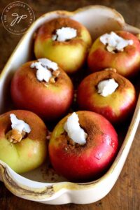 Step three is to add a small pat of coconut oil on top of each apple.