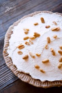 A vertical shot of this finished, uncut, Easy Peanut Butter Pie.