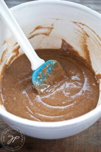 A white mixing bowl holds just-mixed Waffle Iron Cookie batter.