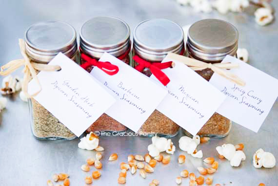 Homemade Popcorn Seasoning in four different jars with labels.