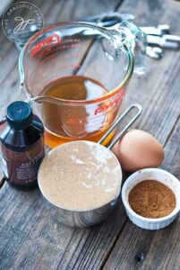 All the waffle iron cookie ingredients gathered on a wood surface.