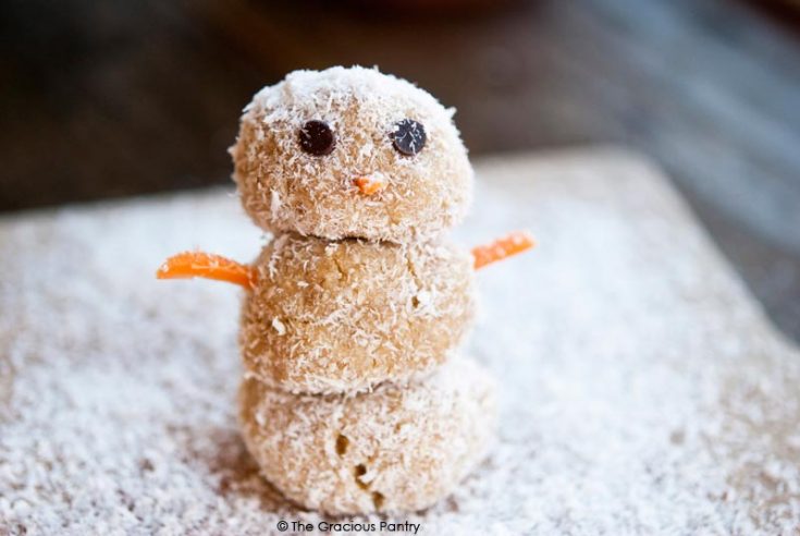 The finished snowman is shown here for this recipe for Clean Eating Energy Ball Snowmen.