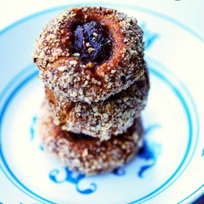 A stack of these thumbprint cookies sit in a decorative bowl.