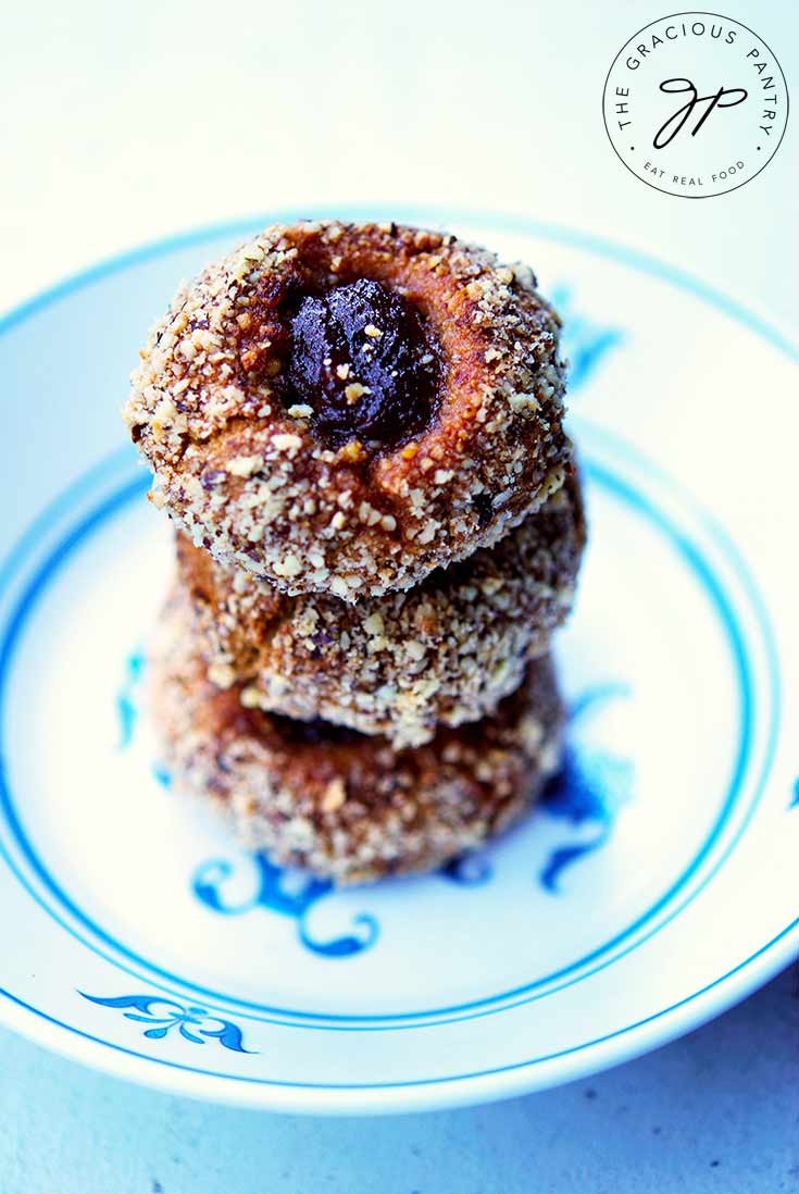 A stack of healthy thumbprint cookies sit in a decorative bowl.