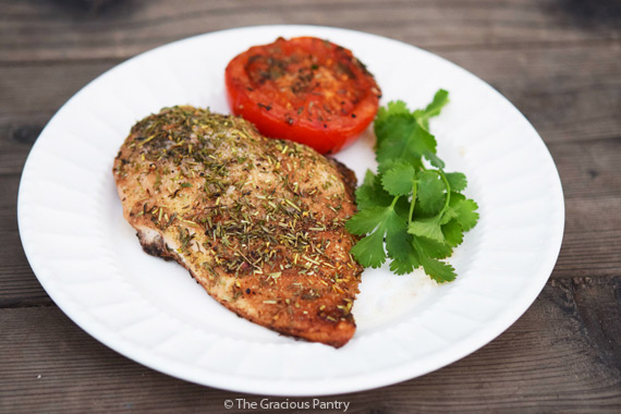 Roasted Balsamic Chicken And Tomatoes on a white plate.