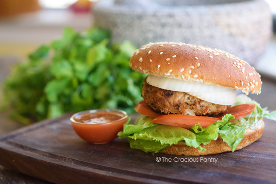 A taco burger sitting on a cutting board.