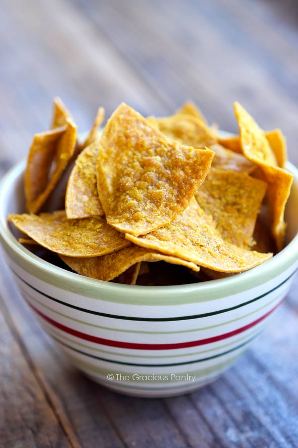 Side view of a bowl filled with these homemade Doritos.