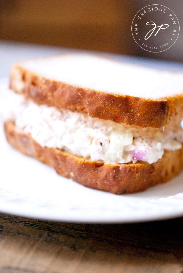 close view of a plated Tuna Fish Sandwich made with two slices of whole grain bread.