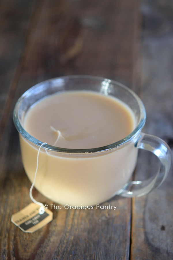 A clear mug filled with this London Fog Recipe using flat milk instead of frothed.