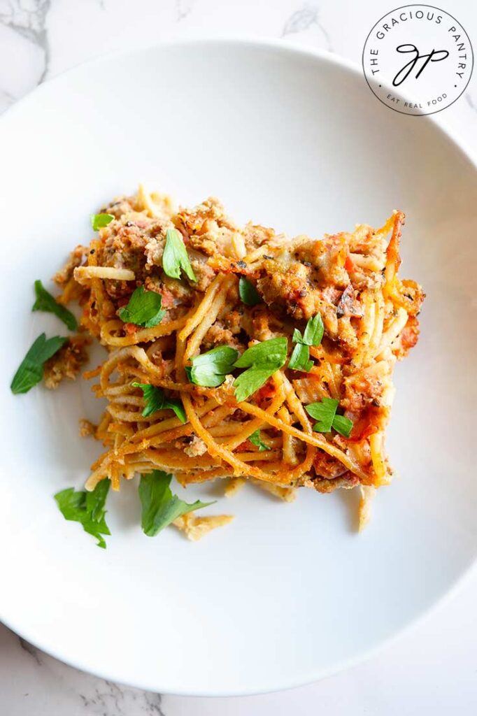 A slice of spaghetti pie in a white bowl.