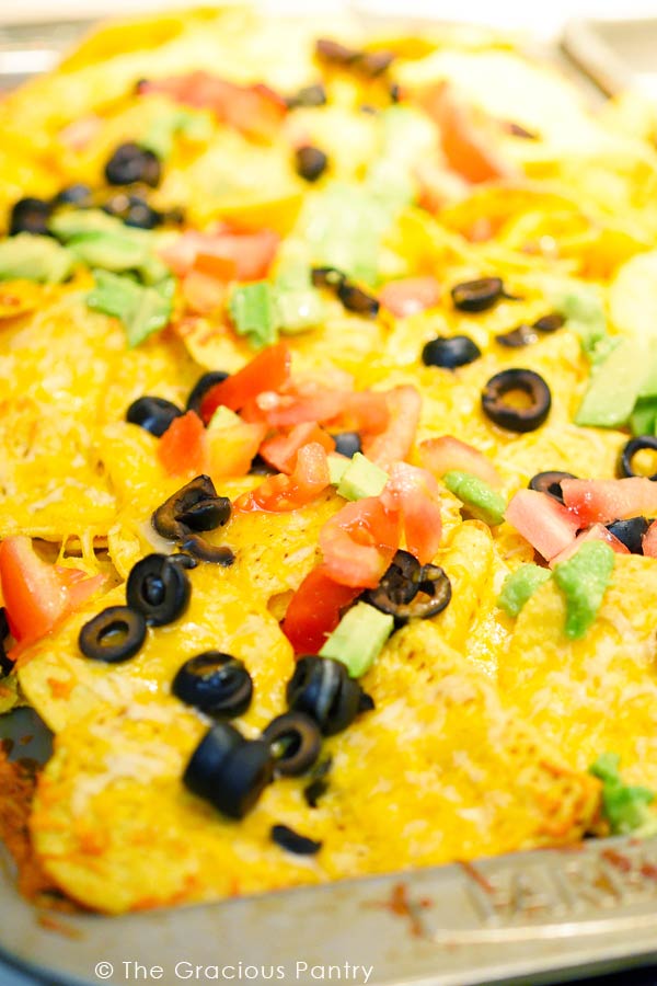 A sheet pan filled with Clean Eating Sheet Pan Nachos pulled right from the oven.