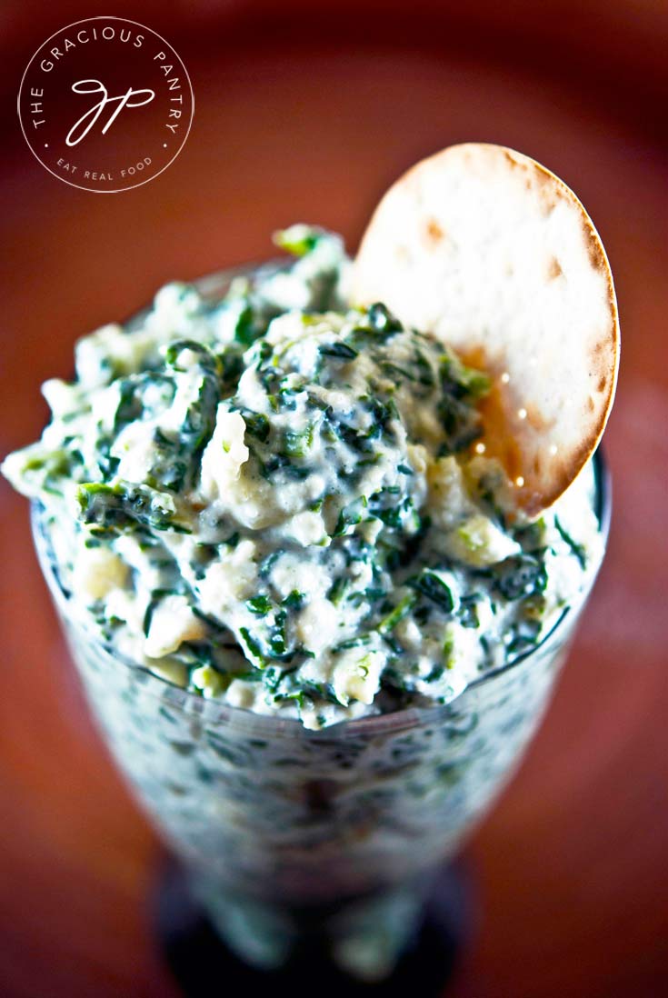 overhead photo - spinach dip recipe made with real food ingredients in a glass dish.