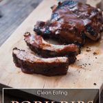 A rack of grilled Pork Ribs on cutting board, slathered in homemade bbq sauce