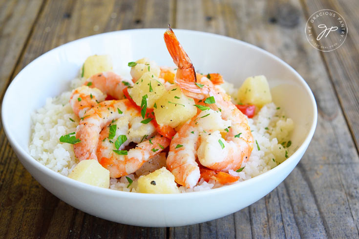 Clean Eating Sheet Pan Pineapple Shrimp Recipe in a white bowl, fresh out of the oven and ready to eat.