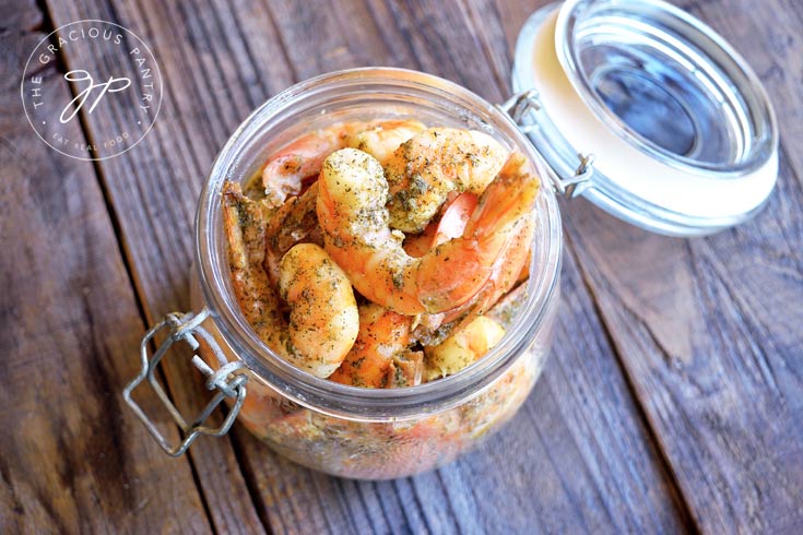 Seafood Marinade in an open canning jar with shrimp inside.