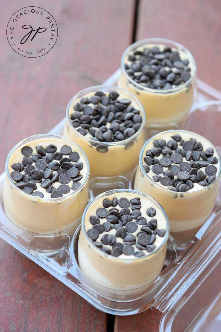 A group of Clean Eating Chocolate Peanut Butter Parfait cups sits in a clear plastic holder.