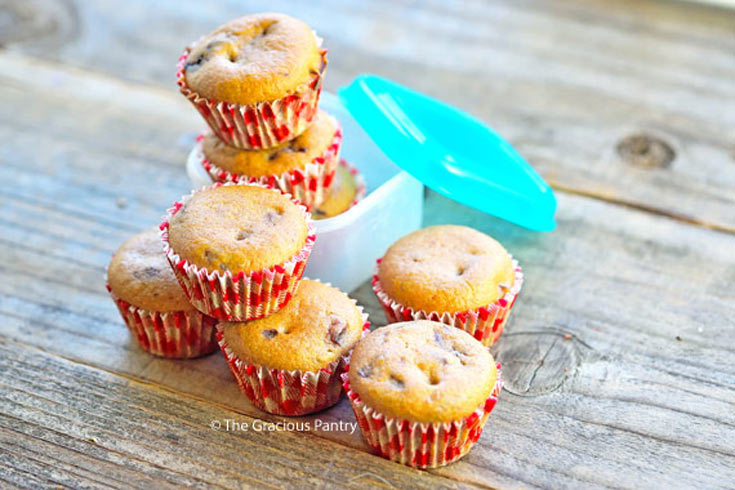 Several Lunchbox Muffins gathered together on a wood surface.