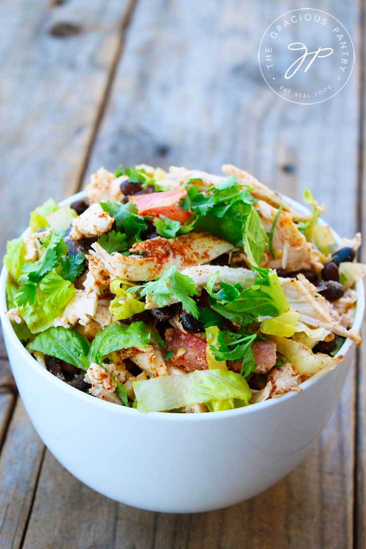 A white bowl filled with this Mexican Chicken Salad Recipe, and topped with chopped, fresh cilantro.