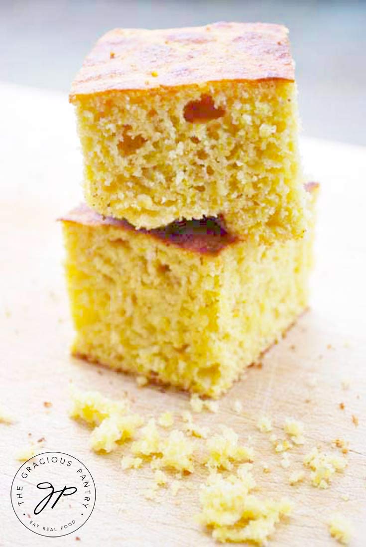 two stacked pieces of fluffy, moist homemade cornbread made with real food ingredients