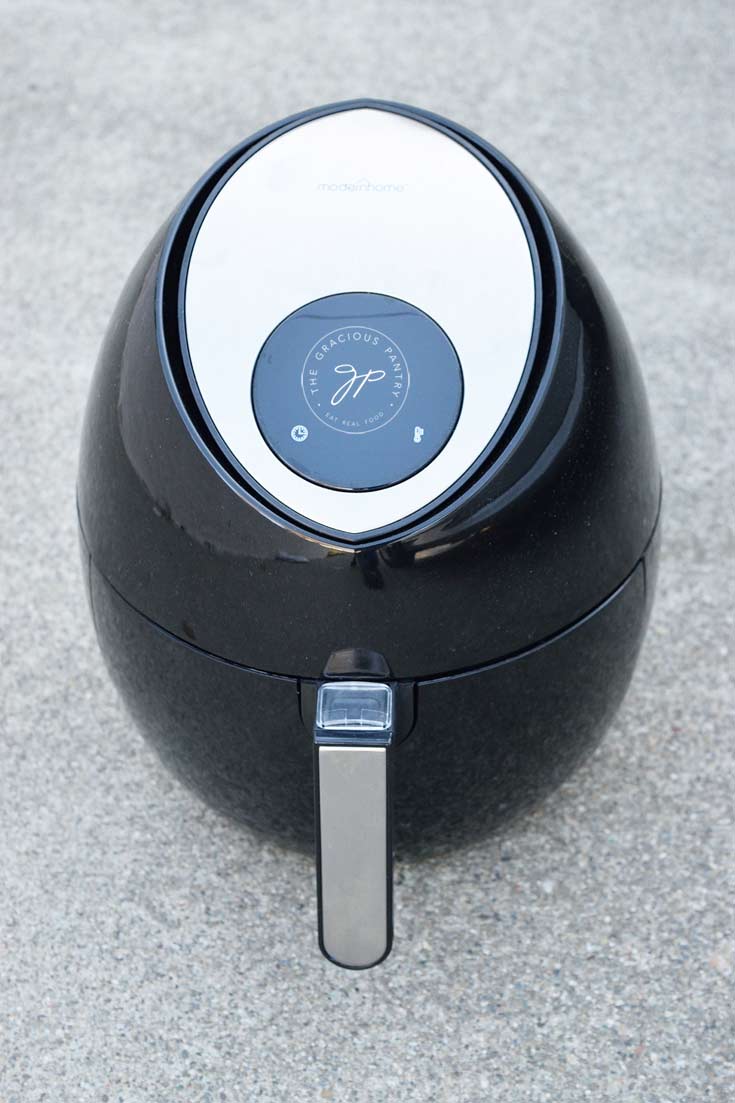 Modern Home Air Fryer on gray, cement background showing the air fryer with it's drawer closed.